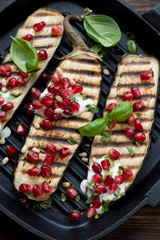 Grilled aubergine with pomegranate seeds, sour cream and nuts