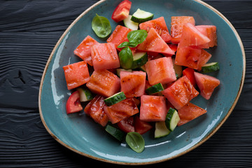 Salad with grilled watermelon, tomato and cucumber, close-up