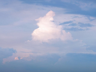 Naklejka na ściany i meble White cream shaped clouds in blue sky background.