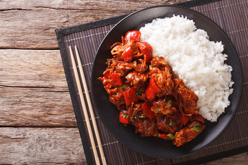 Chinese food: pork in sweet and sour sauce with rice close-up. horizontal top view
