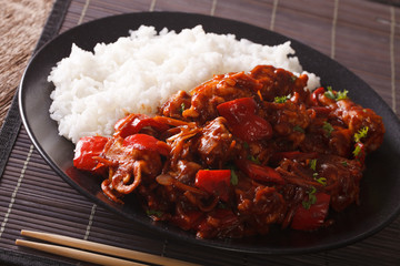 Pork with vegetables and garnish rice in Asian style. Horizontal
