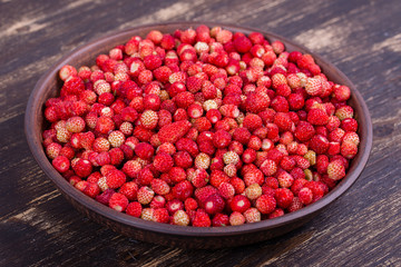 Fresh, ripe strawberries , wild berry on the wooden table