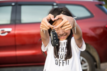 Used car key remote control in hand girl.