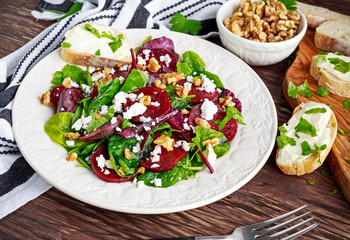 Healthy Beet Salad with fresh sweet baby spinach, kale lettuce, nuts, feta cheese and toast  melted 