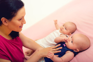 Mother with her twins. Moment of tenderness