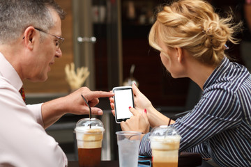 Business man showing info on blank smart phone screen