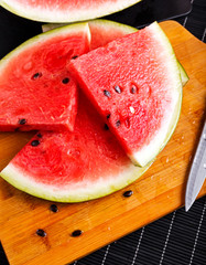 slices of watermelon on wooden board