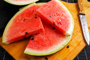 slices of watermelon on wooden board