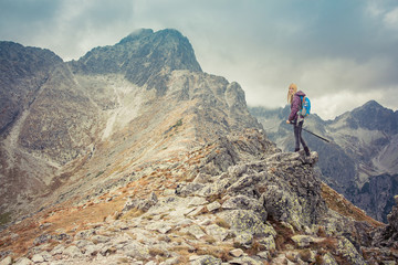 woman adventure hiker on mountain summit