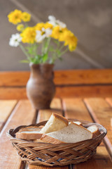 wicker basket with bread and flowers