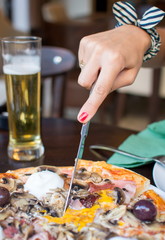 Woman eating pizza at the restaurant