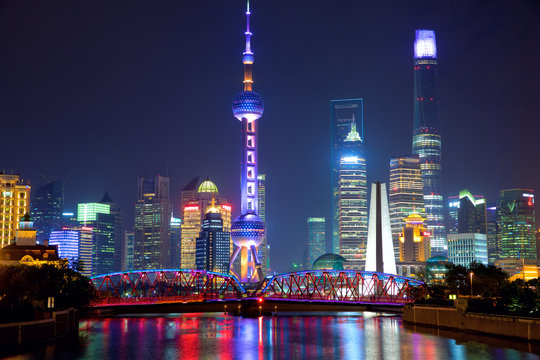 Shanghai skyline at night with illuminated Waibaidu bridge, China