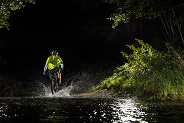 Mountain biker riding in forest stream