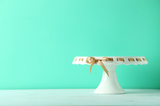 Cake stand on a green wooden table