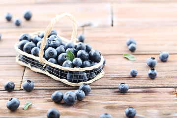 Ripe and tasty blueberries on brown wooden table