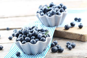 Ripe and tasty blueberries on grey wooden table