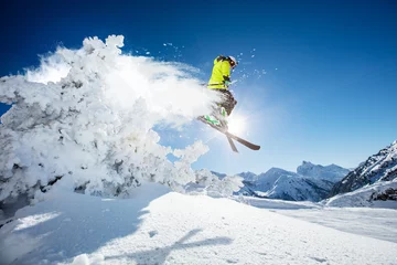 Schilderijen op glas Skier at jump in Alpine mountains © Jag_cz