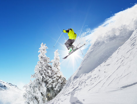 Skier at jump in Alpine mountains