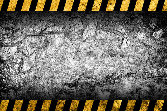 Grunge grey marble background with black and yellow warning stripes
