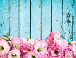 Beautiful flowers on vintage wooden background.