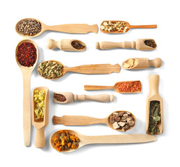 Natural flower and herb selection in wooden spoons isolated on white