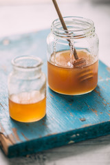 Honey in a pot or jar on kitchen table