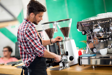 Satisfied barista steaming milk