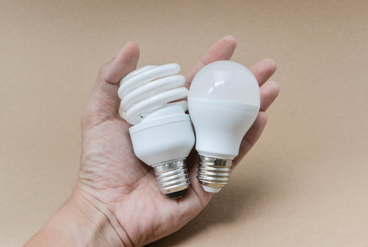 LED bulb and Fluorescent bulb on hand -  The choice of lighting for saving