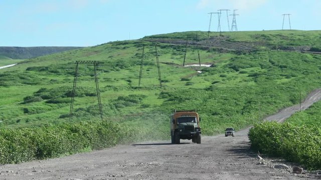 Offroad bus goes along power line, Kamchatka