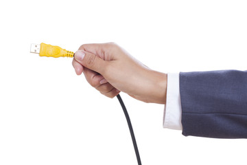 Businessman hand holding USB cable.