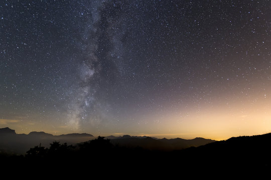 Milky way landscape over mountain silhouette
