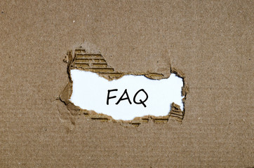 The word faq appearing behind torn paper