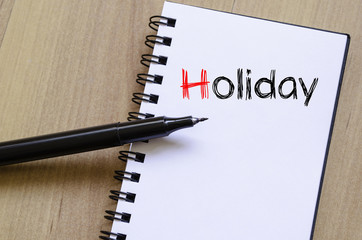 Holiday text concept on notebook