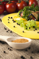 cold appetizers of eggplant on a kitchen board with herbs, tomatoes, pepper and spice