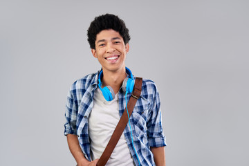 Confident relaxed mixed race guy with afro smiling