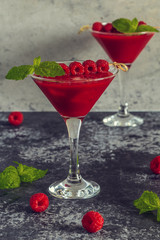 Red cocktail with raspberries.