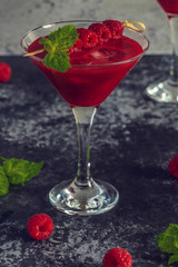 Red cocktail with raspberries.