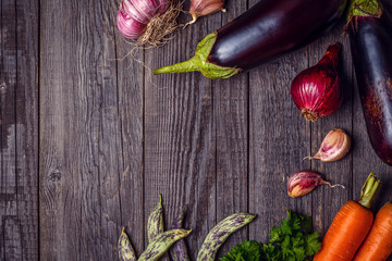 Fresh vegetables for cooking on dark wooden background with spac