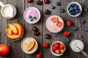 Homemade yogurt with fresh strawberry, blueberry, peach on a woo
