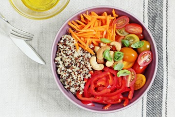 Quinoa bowl with raw vegetables and nuts. Superfoods and clean eating concept. Selective focus