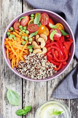 Quinoa bowl with raw vegetables and nuts. Superfoods and clean eating concept. Selective focus 