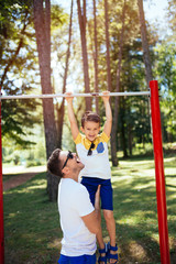 Obraz premium Father and son playing together in a park.