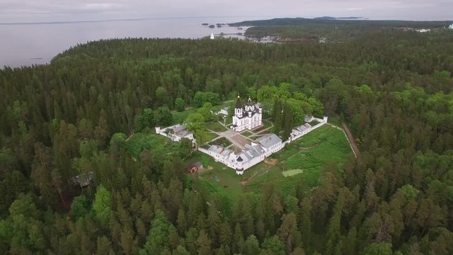 The Skete of All Saints. Valaam Island, Karelia from above. Monastery dramatic aerial drone video. Unique Russian historical and religion tourism place. Lake Ladoga. Pine forest. 4K footage.