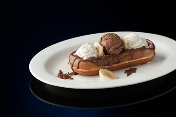 Fototapeta na wymiar Waffles and ice cream in a dish on a dark background