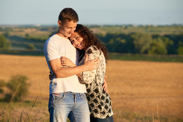 happy young couple posing high on country outdoor, romantic people concept, summer season