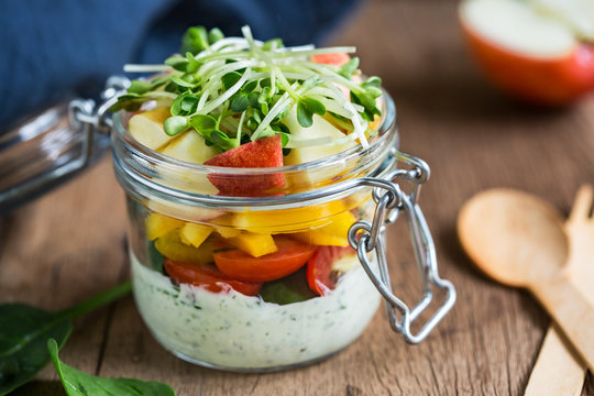 Spinach,apple and tomato salad in a jar