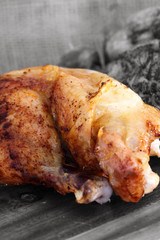 Roast chicken thigh chopping board / Roast chicken thigh on a wooden chopping board with selective color