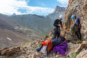Afwasbaar Fotobehang Alpinisme Mountain climbers preparing for ascent