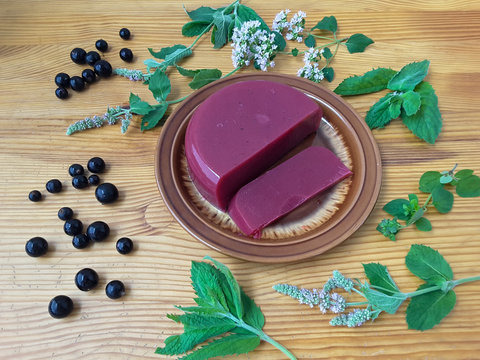 Red jelly berries on plate, with mint decorated, organic healthy sweet food