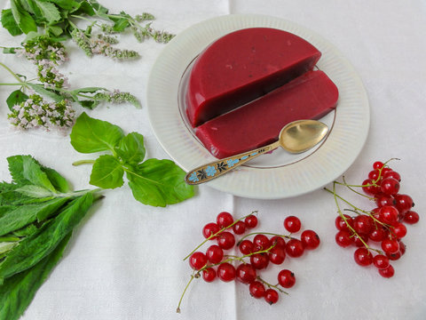 Red jelly berries on plate, with mint decorated, organic healthy